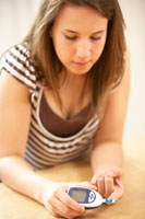 A girl checking her blood sugar level.