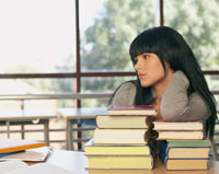 Girl with a stack of books.