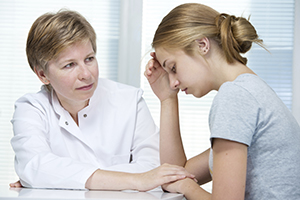 A girl talking to a therapist.