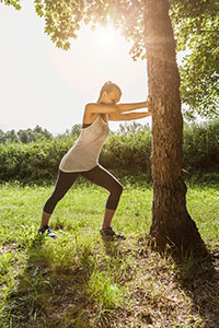 A girl doing a calf stretch