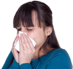 Photo of a girl blowing her nose.