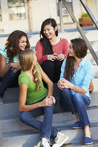 A group of friends sitting on stairs.